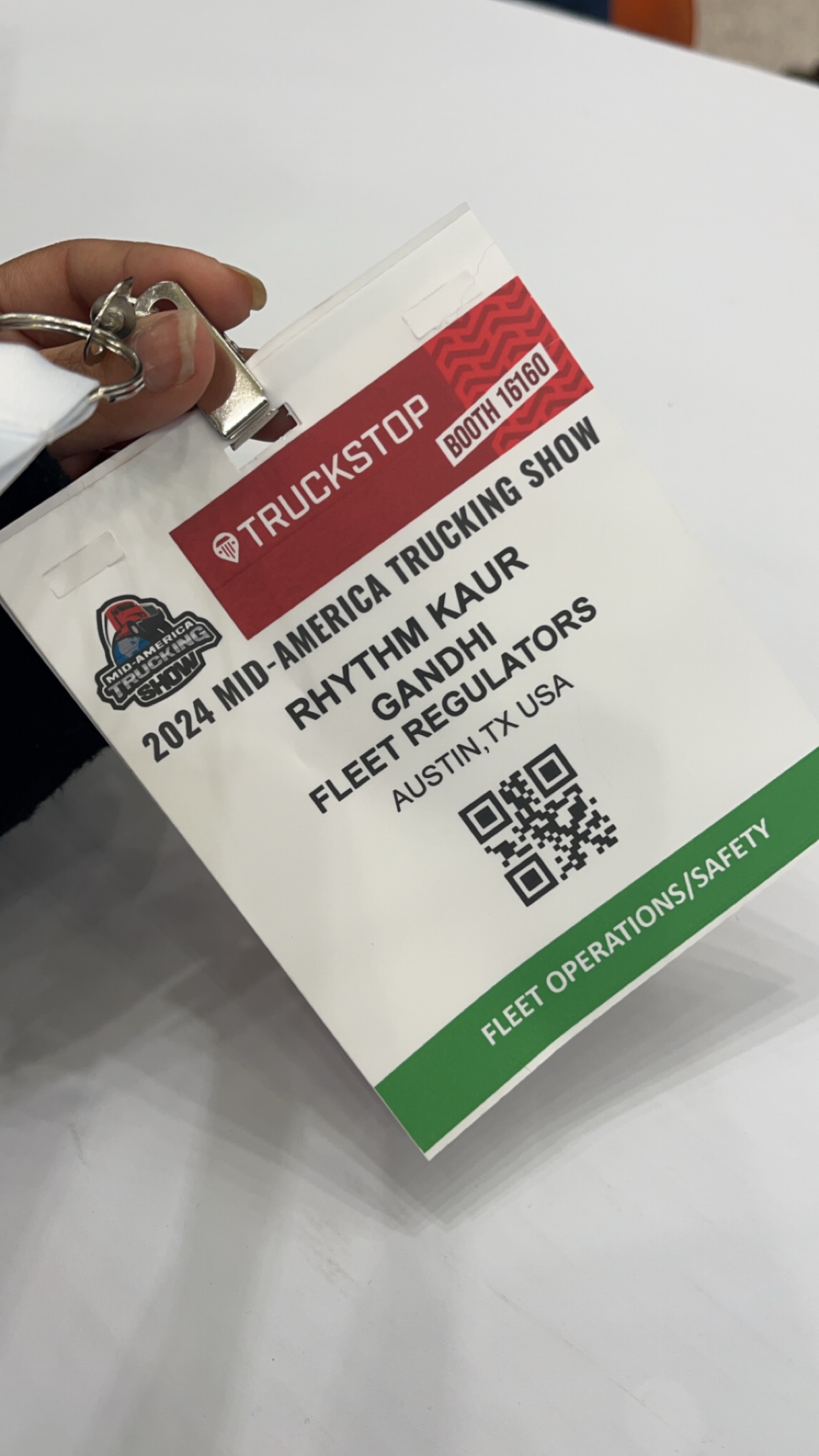 Rhythm Gandhi's Fleet Regulators exhibitor badge at a trucking industry conference